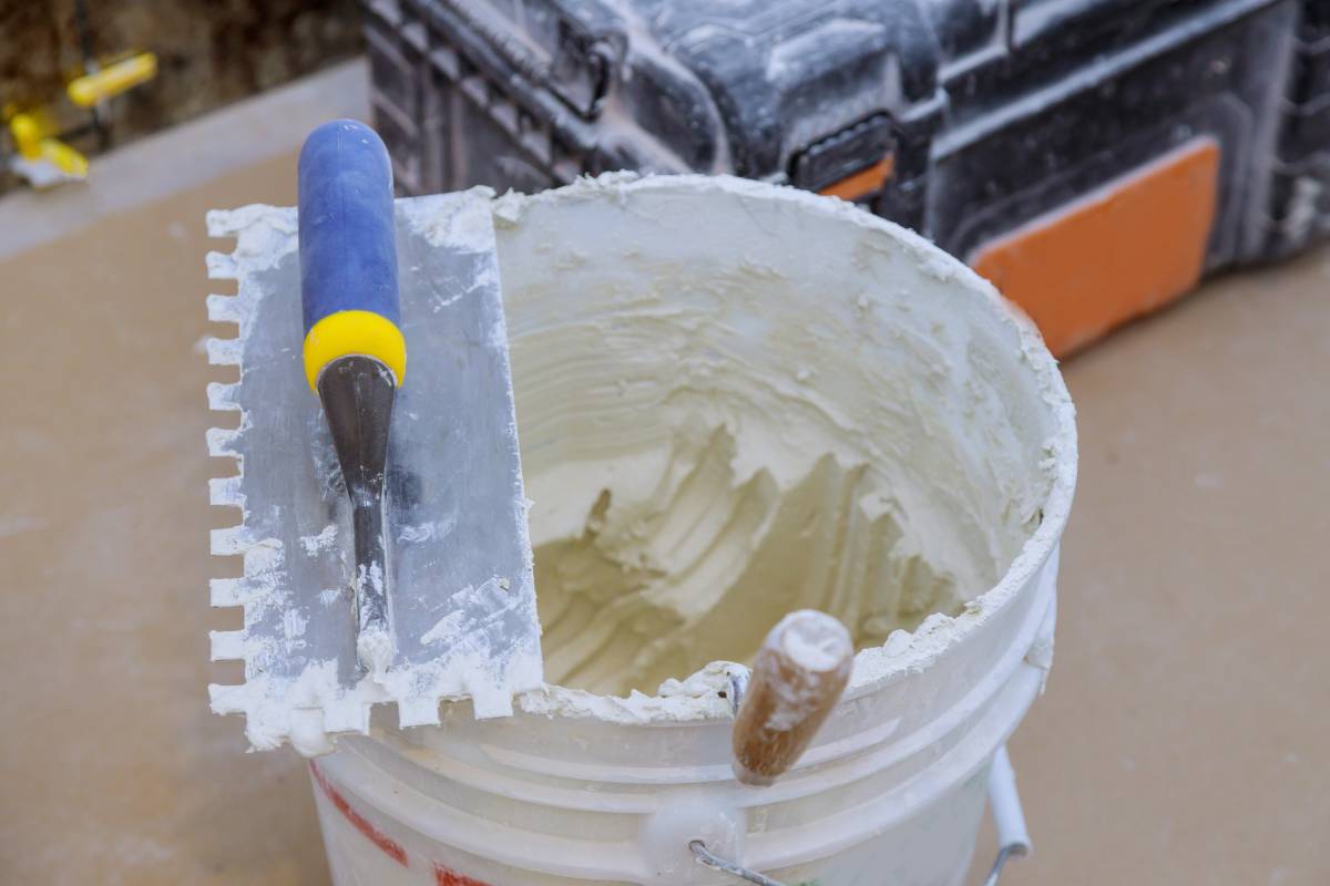 Trowel mortar tIling a closeup with new cement trowel ceramic tiles.